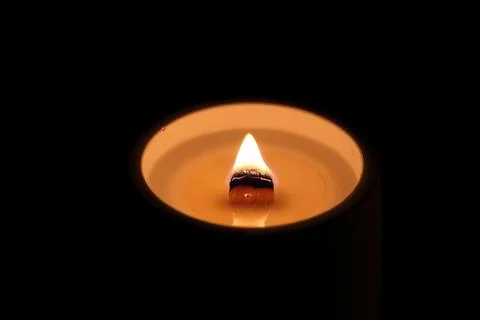 Candle light on a black background, close-up of photo Stock Photos