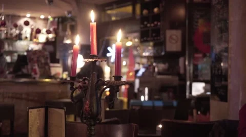 Candle light burning in a bar in Paris at dusk Stock Footage 58016322