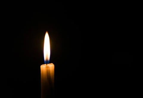 Candle light flame. Concept of memory, remembrance, mourning, grief, and sorrow. Stock Photos