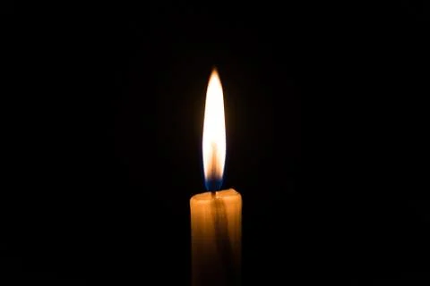 Candle light flame. Concept of memory, remembrance, mourning, grief, and sorrow. Stock Photos