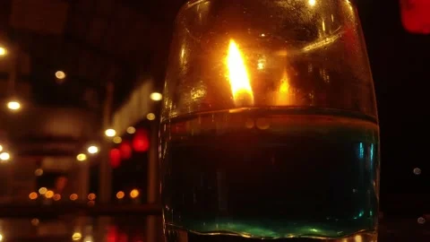 Candle light in the glass on table with blurred background. Stock Footage 221353094