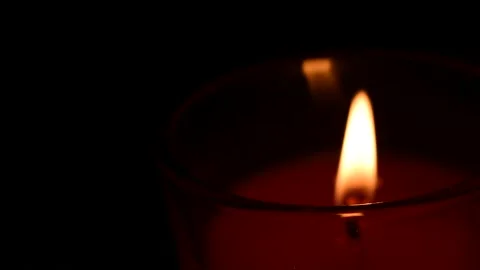 Candle light glowing in the darkness Stock Footage