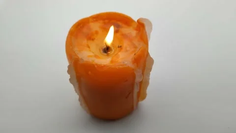 Candle on a light gray background Stock Footage 166398543