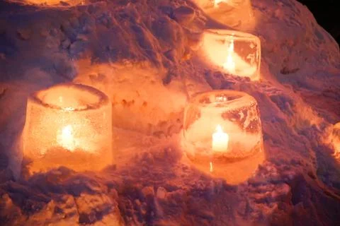 Candle light in ice and snow on Christmas day Stock Photos