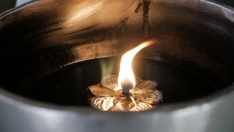 A candle light inside floating on water vessels Stock Photos