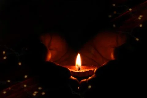 A candle light keeps in darkness Stock Photos