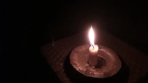 Candle light in the midst of darkness becomes a light for life. Stock Footage 337757042
