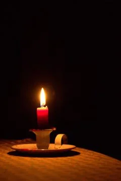 Candle light on a table, shining in the dark Stock Photos