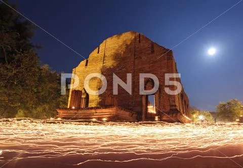 Candle light trail of buddhism ceremony at temple ruin with moon on asalha pu Stock Photos