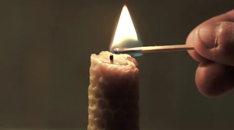 Candle lights up and being blown out slowly Stock Footage 34682861