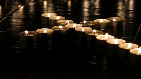 Candle lights in the shape of a cross in room at night Stock Footage 141894977