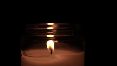 Candle Lit in Darkness with Soft Glow. 스톡 동영상 306858341