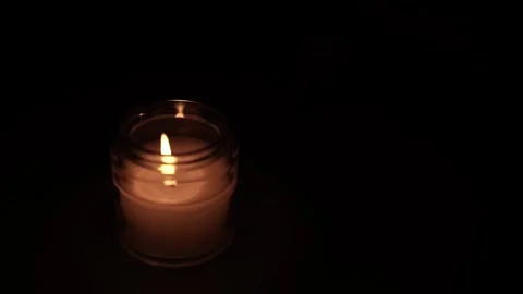 Candle Lit in Darkness with Soft Glow. Vídeo Stock 306858601