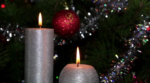 Candle lit in front of festive lights Christmas tree, FULL HD Stock Footage 32503095