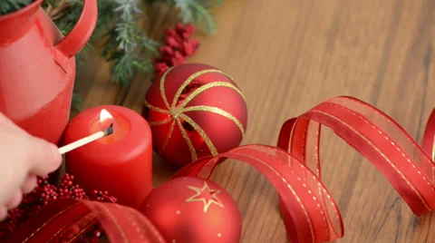 Candle is lit next to Christmas tree balls and pine green 스톡 동영상 32503520