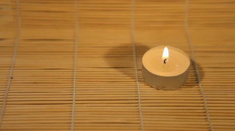 Candle lit tablet on a bamboo mat Stock Footage 40493848