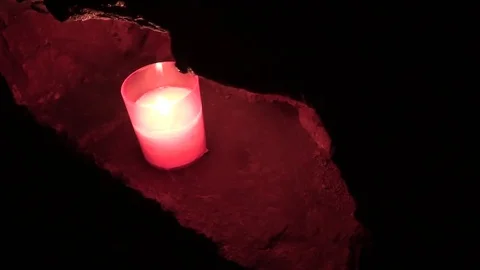 Candle night in a brick wall. Darkness and red light. Stock Footage 77236333