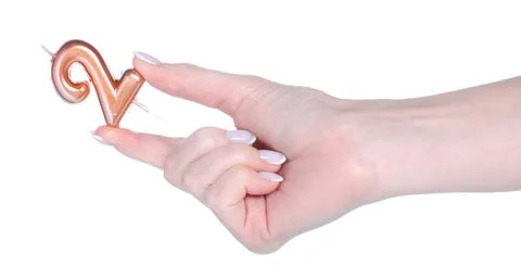 Candle with number 2 in hand Stock Photos