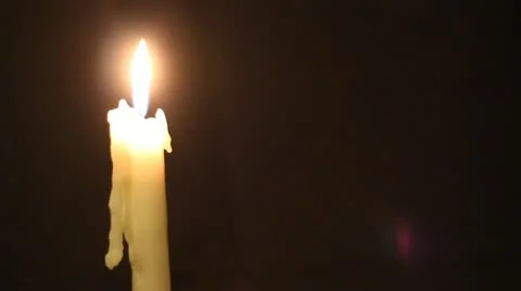 Candle over black background Stock Footage