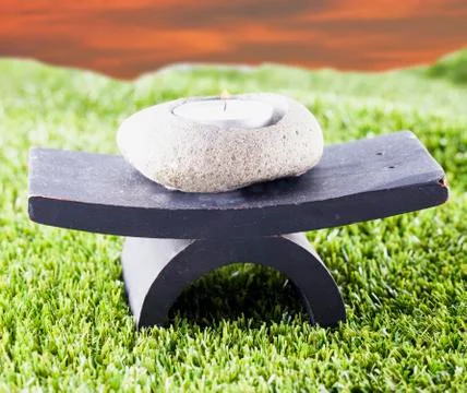Candle over grass Foto stock
