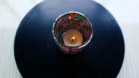 Candle rotating on dark background. Candle in colorful jar 스톡 동영상 113524286