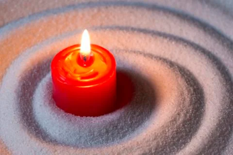 Candle on sand Фото