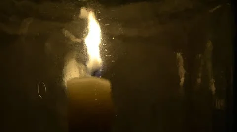 Candle seen through the glass of a rotating lantern Stock Footage 22362273