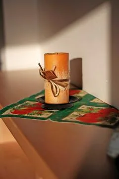 Candle on the shelf by the wall Stock Photos