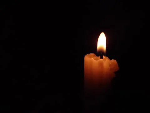 A candle shining in dark Stock Photos