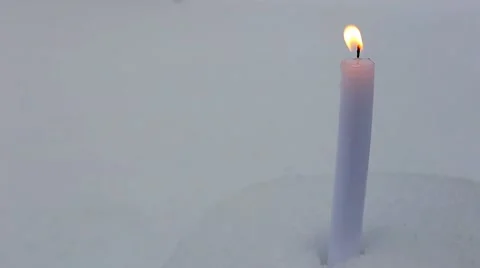 Candle on snow Stock Footage 66439373