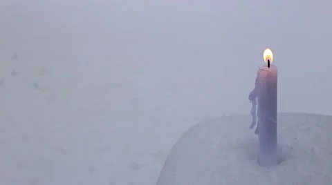 Candle on snow Stock Footage 66439405