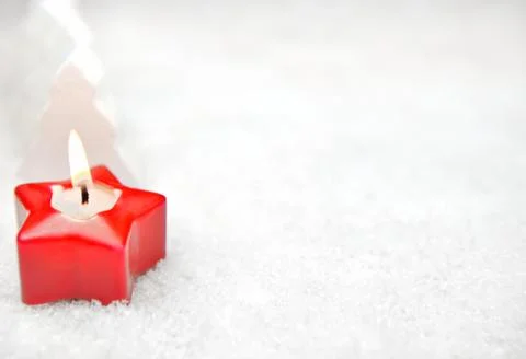 Candle in the snow Stock Photos