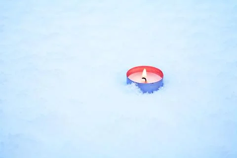 Candle In Snow Stock Photos