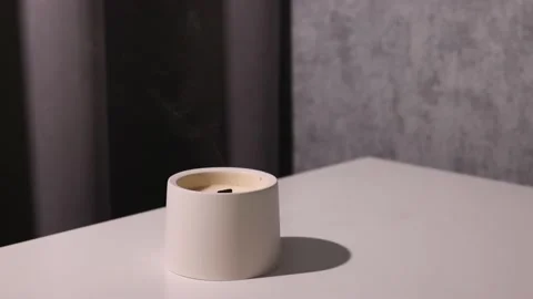 Candle soy homemade in ceramic burning in grey modern interior room, atmosphere Video stock 196629341