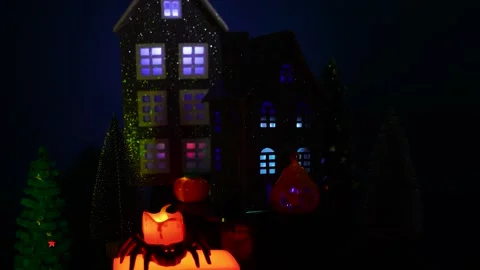 A candle in a spider candlestick against the backdrop of a Halloween town Stock Footage 319421275