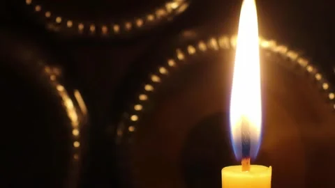 A candle swaying and burning in the breeze shines beautifully Stock Footage 166403719