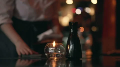Candle on table restaurant waitress background Stock Footage 144653697