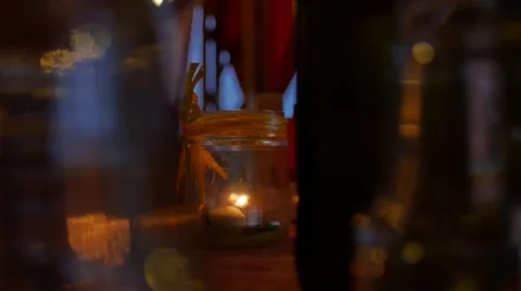 Candle on table at a romantic dinner 스톡 동영상 57309990
