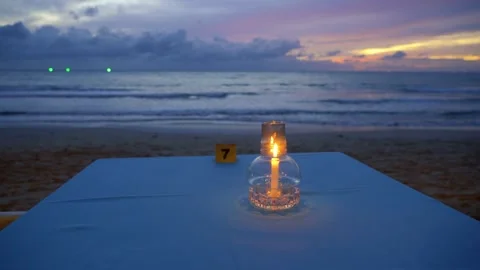 Candle on a table in a sea beach at evening . Stock Footage 246800567