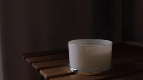 A candle with three wicks on table. put out candle. candle creating Stock Footage 293071170