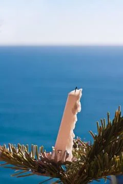 Candle on a tree in front of the sea Stock Photos