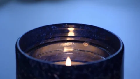 Candle on a white table in the evening. Close up video. Shallow DoF. Stock Footage 319033484