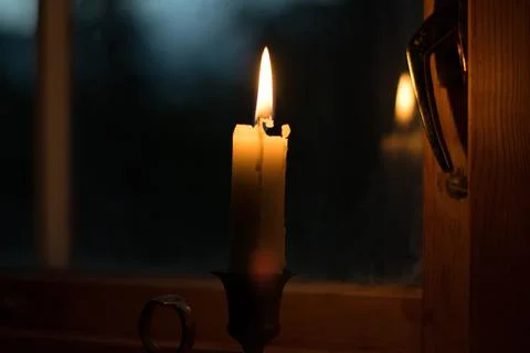 Candle on the window with evening background Stock Photos