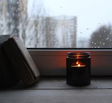 Candle on the window Stock Photos