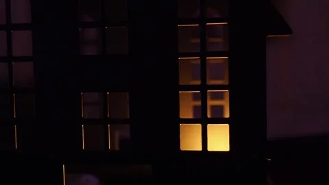 Candlelight casts flickering shadows in a dark castle, illuminating windows Stock Footage 319745243