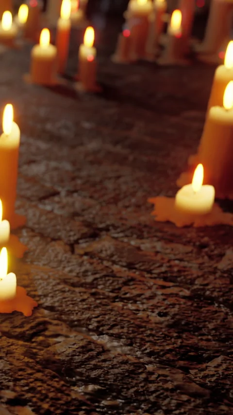 Candlelight creates soft glow on textured surface during quiet evening scene Stock Footage 335098681