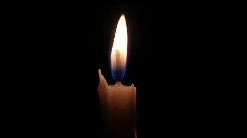 Candlelight flickers softly in a dark room Vídeo Stock 333861726