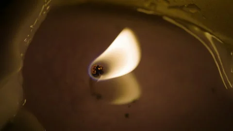 Candlelight glowing and burning with melted wax around. Stock Footage 130284518