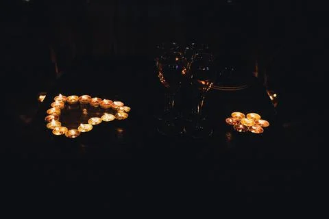Candlelight glows softly on a dark surface Fotos de archivo