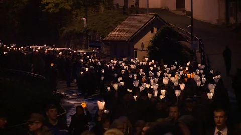 Candlelight Marian procession through the streets of Lourdes, France at night. Stockbeeldmateriaal 86758455